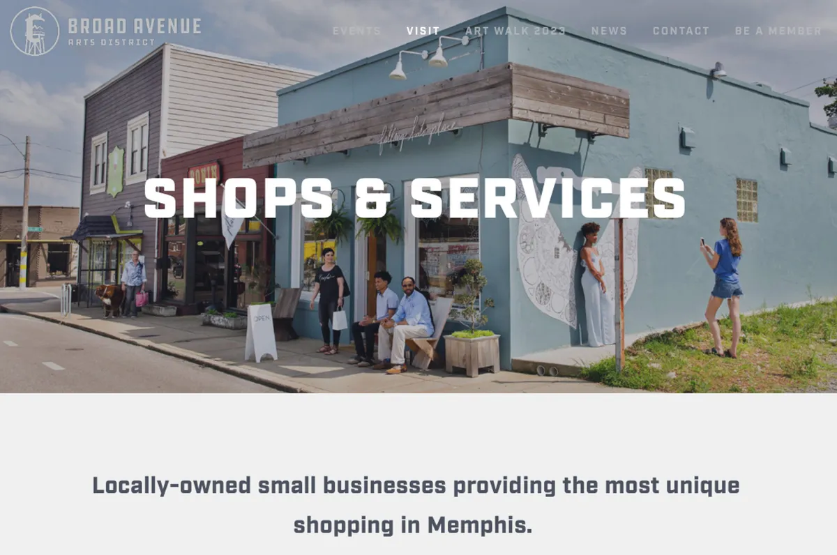 This image captures a bustling streetscape with colorful storefronts, an artistic mural, and people engaged in shopping and socializing. The vibrant street art and the lively crowd suggest a thriving local community with plenty of unique shops and cultural experiences.